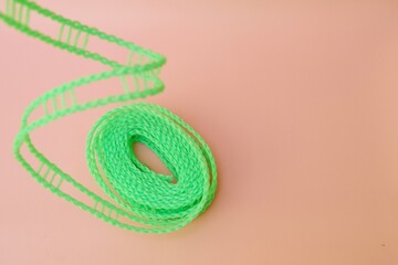 Colourful candles isolated in the green rope on pink background. Birthday,Christmas and special greetings concept. © Hari