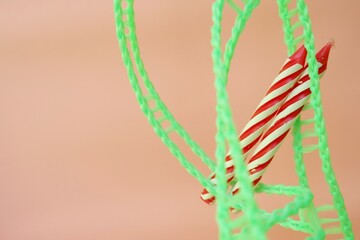 Colourful candles isolated in the green rope on pink background. Birthday,Christmas and special greetings concept. © Hari