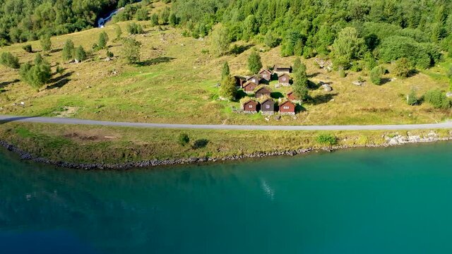 Cattle Shed with Grass top roof near a beautiful lake, Aerial view