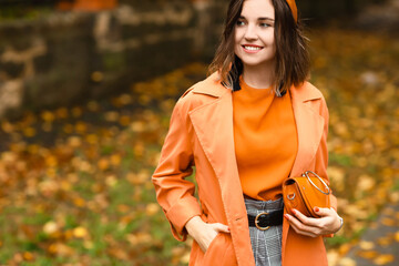 Fashionable woman with stylish handbag outdoors