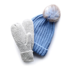 Warm hat and mittens on white background