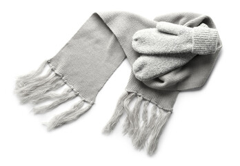 Warm mittens and scarf on white background