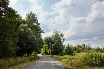 A gravel road at rural Europe. Suburban road path