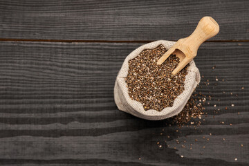  pouch full of Organic natural chia seeds on dark wooden background or table