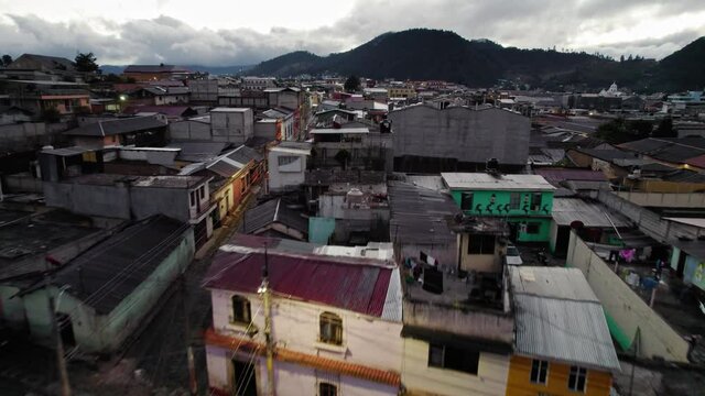 Drone Aerial View Flying Over Urban Colonial Neighborhood Streets And Alleys During Lonely Dawn Morning In Quetzaltenango Xela Guatemala.