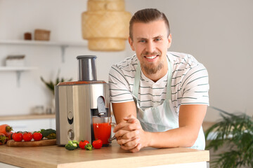 Young man with modern juicer in kitchen