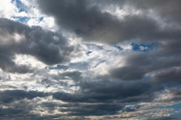 Naklejka na ściany i meble Layers of grey clouds . Cumulus before rain 