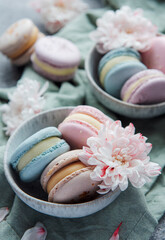 Beautiful colorful tasty macaroons on a concrete background