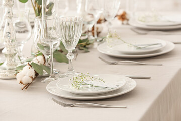 Beautiful table setting with wedding invitations and gypsophila flowers