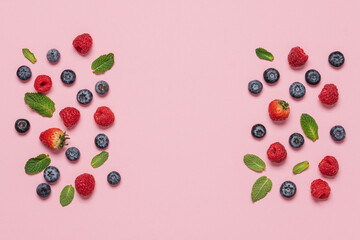 Naklejka na ściany i meble Variety of neatly arranged berries of raspberries, blueberries, strawberries on pink background top view
