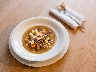 Minestrone Italian Vegetable Soup in an Elegant White Plate with Spoon