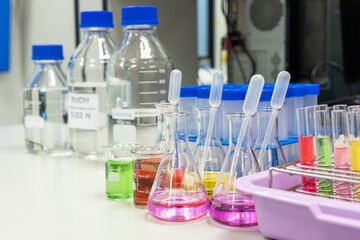 Glass flasks equipment in science chemical laboratory or medical research lab with colorful liquid for research and development concept.
