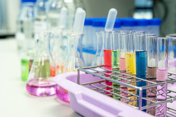 Glass flasks equipment in science chemical laboratory or medical research lab with colorful liquid for research and development concept.