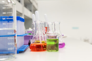 Glass flasks equipment in science chemical laboratory or medical research lab with colorful liquid for research and development concept.