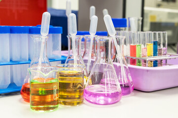 Glass flasks equipment in science chemical laboratory or medical research lab with colorful liquid for research and development concept.
