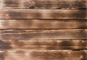 Fototapeta premium brown burnt boards. the background is made of natural wood.