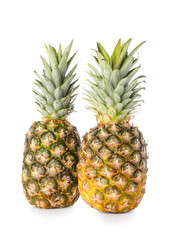Obraz premium Two fresh whole pineapples with green crowns, tropical fruit for healthy eating and refreshing beverages, isolated on white background