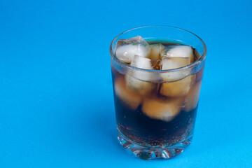 Fototapeta na wymiar cola and ice in a glass. carbonated drink. Glasses of sweet carbonated drinks with ice cubes isolated on white. With clipping path. Background of cola with ice and bubbles.