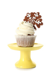 Stand of tasty Christmas cupcake with gingerbread cookie on white background