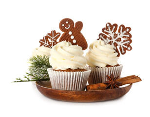 Plate of tasty Christmas cupcakes with gingerbread cookies on white background