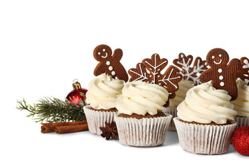 Tasty Christmas cupcakes with gingerbread cookies on white background