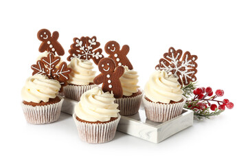 Board of tasty Christmas cupcakes with gingerbread cookies on white background