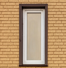 Fototapeta premium Window in a yellow brick wall.