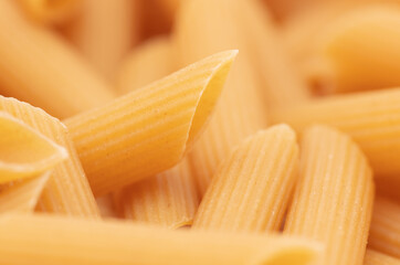 Close-up dry pasta as background.