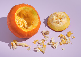 Ripe large orange pumpkin was cut out and a lot of seeds take out of it. Idea autumn harvest and benefits vegetables.