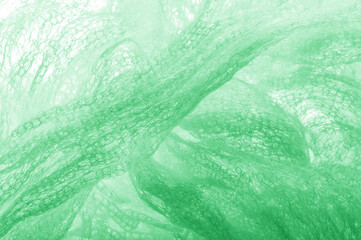 Cloth in a mesh green. Add a line of ethereal brilliance to your decorations and design, Tons of tiny sparkles glitter into the threads to give this fabric a rich, rich and bright tone.