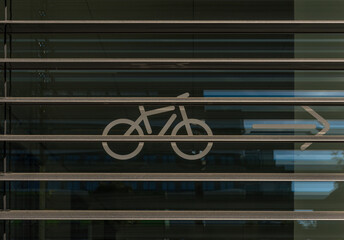 bike sticker on a window pane behind a Window blind
