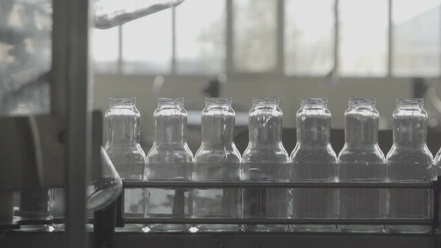 Bottles for compotes on the production line. Slow Motion 100 fps 