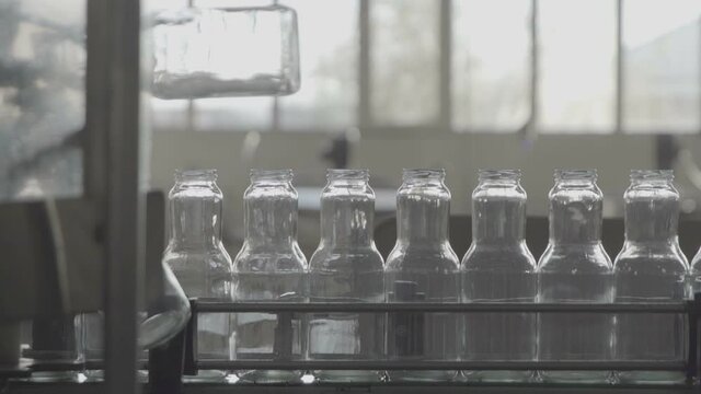 Bottles for compotes on the production line. Slow Motion 100 fps 
