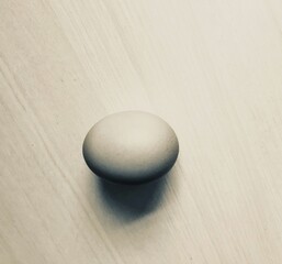 An egg on the table with dim light effect.