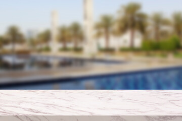 Empty marble table in front of a blurred background. Table in blurred background of east resort- can be used to display or edit your products, simulate to showcase them.