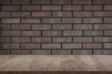 Wooden board empty table in front of light brick wall background. Background blurred. Mock up for display of product
