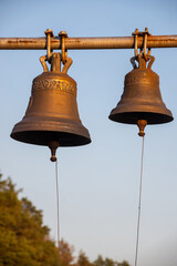 Obraz premium Large Church bell hanging outside. Close-up view of metal orthodox church bell