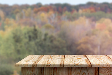 Blurred forest background. Empty table, podium in the foreground. Autumn
