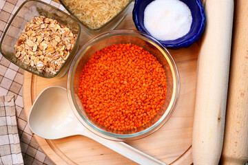 Glass container with lentils . Kitchen utensils. Lentils, oatmeal, rice and sugar 