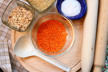 Glass container with lentils . Kitchen utensils. Lentils, oatmeal, rice and sugar 