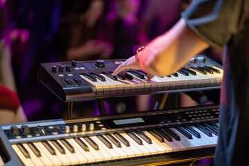 Close up of a keyboardist musician at work at a concert