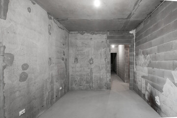 A new unfinished apartment room made of concrete and foam blocks without finishing and decoration works.
