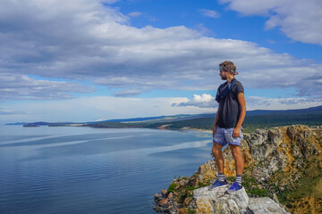 Naklejka premium The guy on the cliff of the Olkhon island at Baikal