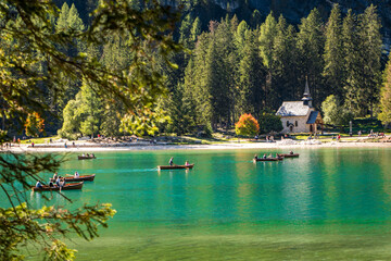 wooden boats swimming on pragser wildsee on a sunny day