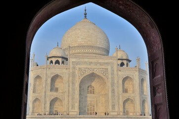 Fototapeta na wymiar View through an arch to the mausoleum of Taj Mahal