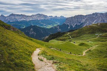 view on hiking trail in the dolomites mountains on a sunny day