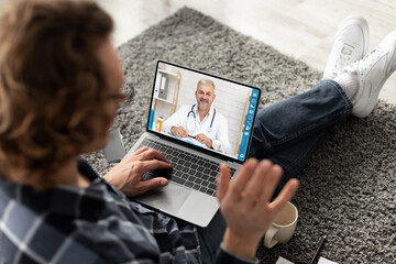 Man having video chat with his doctor, using laptop