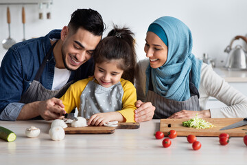 Caring Islamic Parents Teaching Their Adorable Little Daughter How To Cook