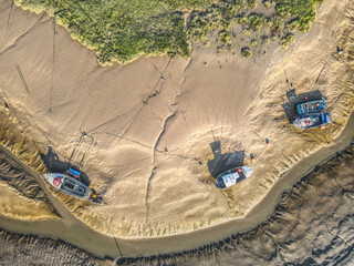 Small fishing boats moored in the Stone Creek inlet at Sunk Island, East Yorkshire, UK