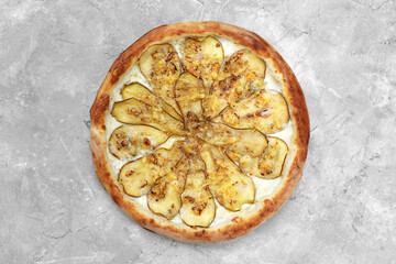 Pizza with pear, gorgonzola and on stone background. Top view.